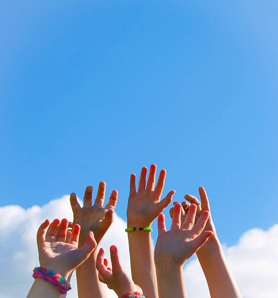 istock Children's hands reaching for the sky 493888845