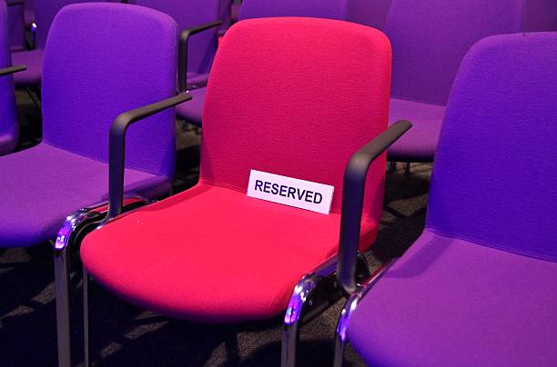 Reserved chairs in conference hall Reserved chairs in large conference hall reserved stock pictures, royalty-free photos & images