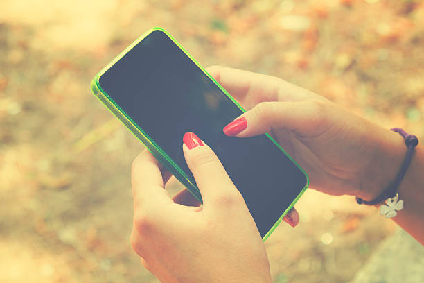 istock Young woman using cellphone outdoors. 493890132