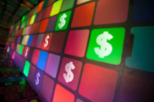 Photo of Dollar Signs Moving on Colorful Digital Screen
