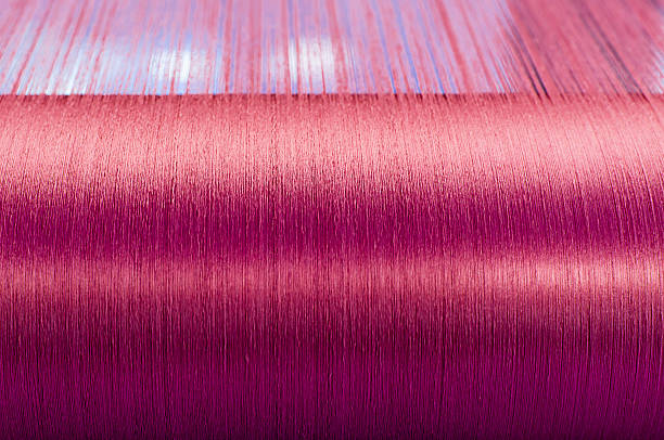 istock Green silk on a warping loom of a textile mill 493892468