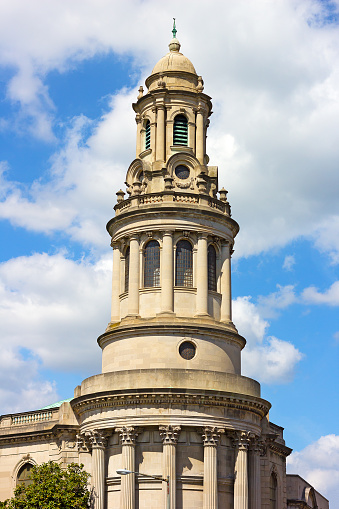 The church top against a cloudy blue sky.