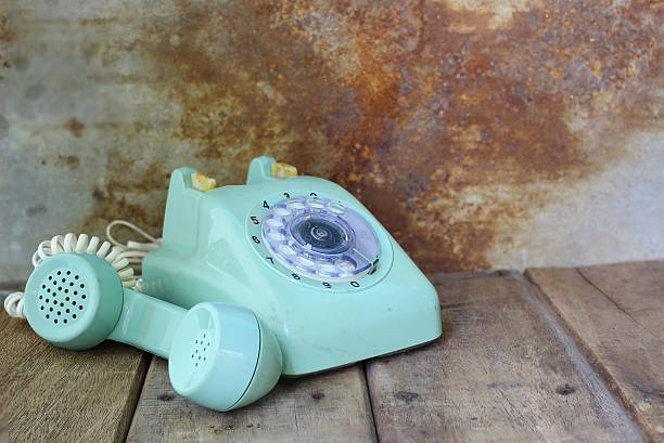 istock Green vintage telephone on wooden table 493910670