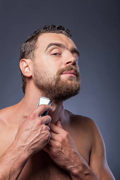 istock Cheerful bearded guy is caring of his appearance 493913304