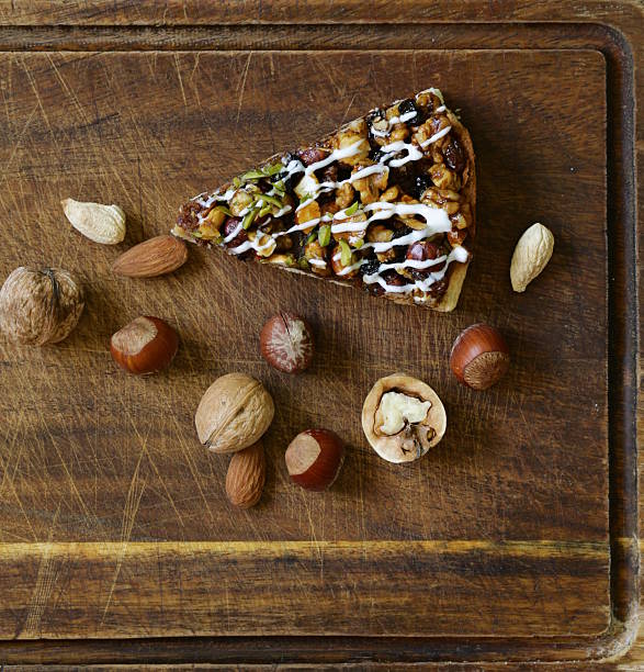 piece of pecan pie tart with various nuts