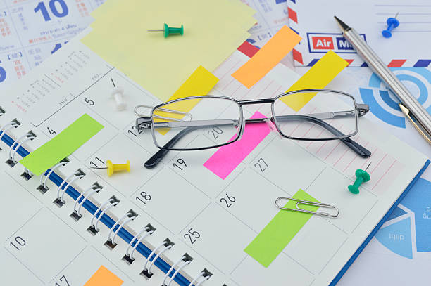 istock Glasses with colorful sticky notes and pen on diary page 493914462