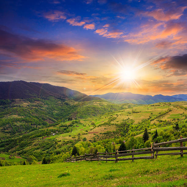 istock fence on hillside meadow in mountain at sunset 493914599