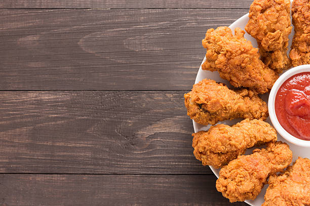 istock fried chicken drumstick and ketchup on wooden background 493914860