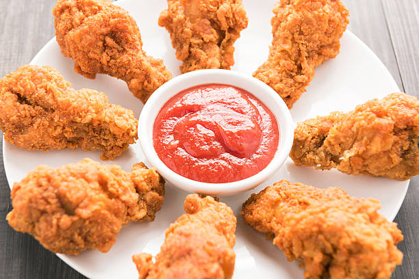 istock fried chicken drumstick and ketchup on white dish 493915724