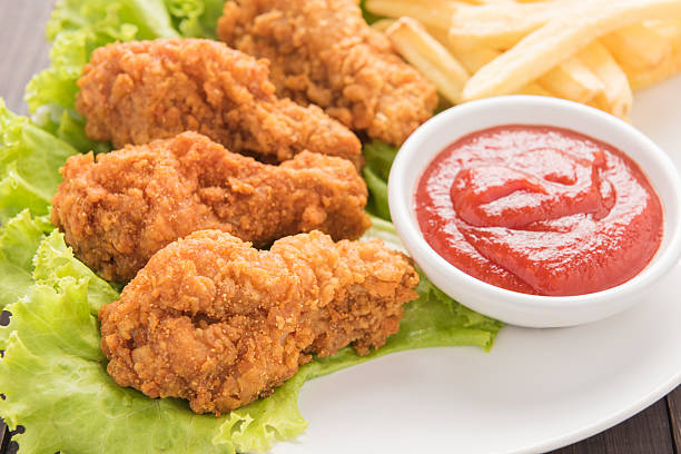 istock fried chicken drumstick and french fries on white dish 493916400
