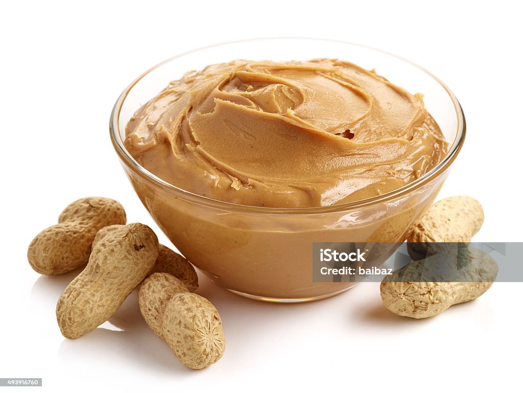 Peanut butter Glass bowl of peanut butter with peanuts isolated on white background Peanut Butter Stock Photo