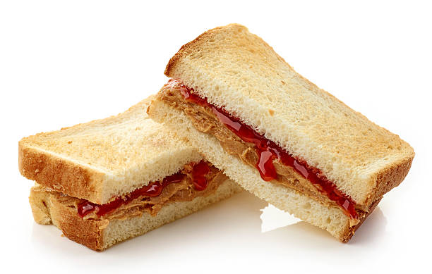 Peanut butter jelly sandwich Peanut butter and strawberry jelly sandwich isolated on white background peanut butter and jelly sandwich stock pictures, royalty-free photos & images