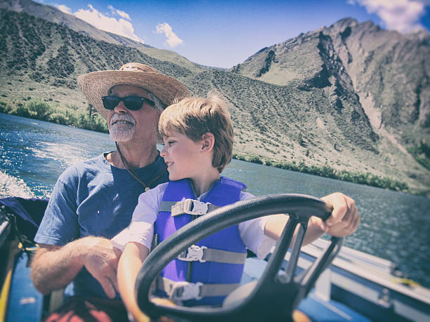 Child Mountain lake boating with Grandpa