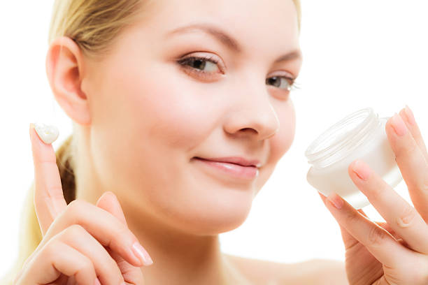 istock Skin care. Girl applying moisturizing cream 493917827