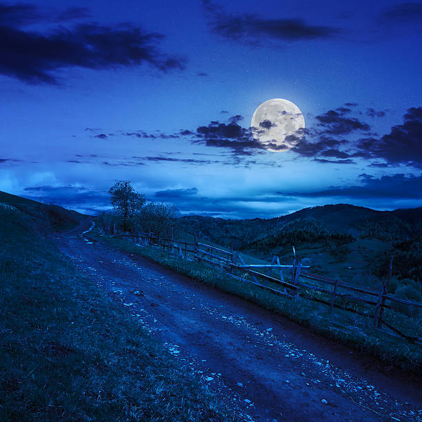 istock fence on hillside meadow in mountain at night 493917997