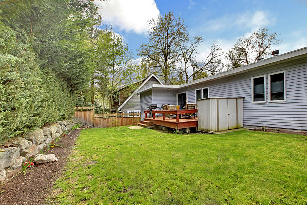 istock Back yard of the small grey house wth simple deck. 493918617