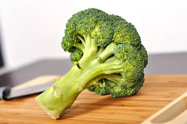 fresh green broccoli on a kitchen board