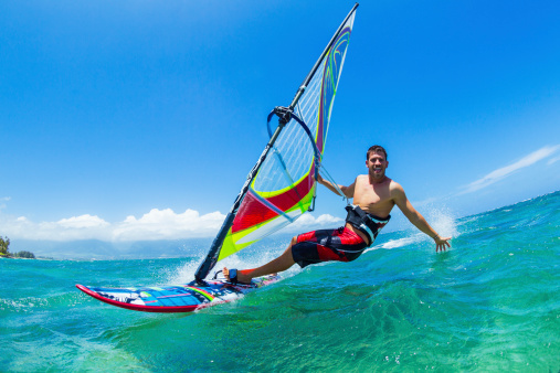 Chichester, United Kingdom – October 26, 2022: A windsurfer performing stunts in the water