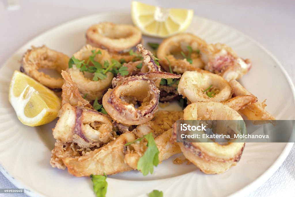 Fresh fried calamary rings A plate of fresh fried calamary rings with lemon Calamari Stock Photo