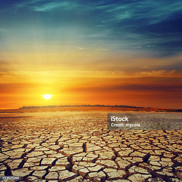 Drought Land And Sunset Over It Stock Photo - Download Image Now - 2015, Accidents and Disasters, Arid Climate