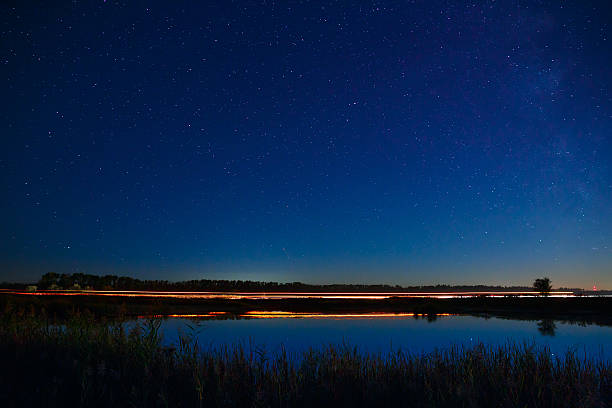 istock The stars in the night sky reflected in the river. 493931332