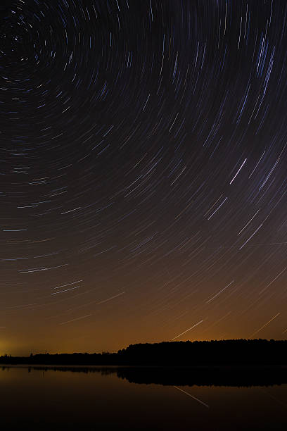 istock Smooth surface of the lake on  background  starry sky . 493931626