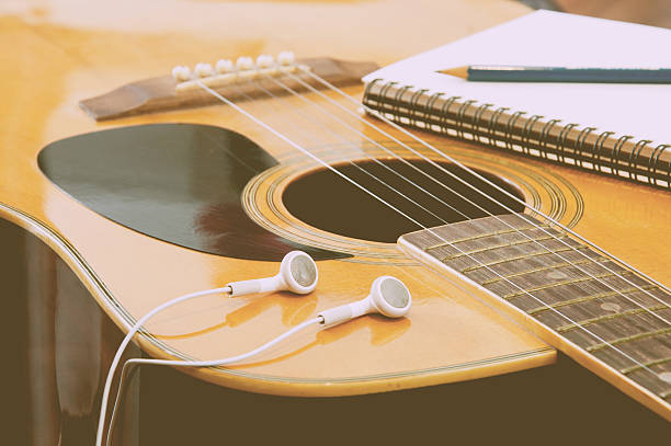 istock Headset notebook and pencil on guitar in vintage tone 493933020