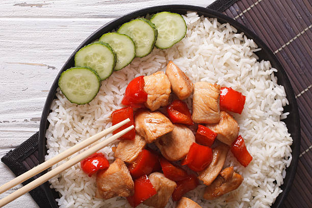 istock rice with chicken and teriyaki sauce horizontal top view 493933408