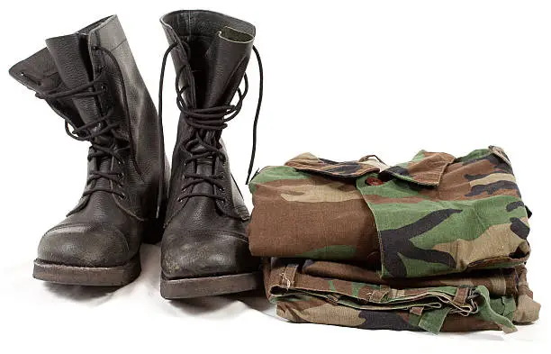 military boots and army soldier uniforms clothing, shoes with camouflage clothes on white background