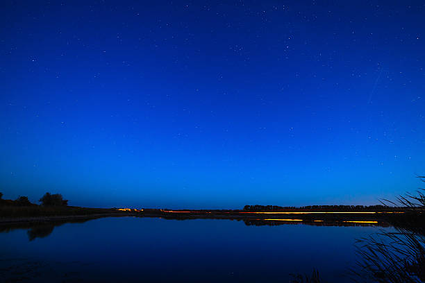 istock The stars in the night sky reflected in the river. 493935328