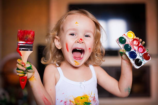 istock girl with brush  paints 493935436