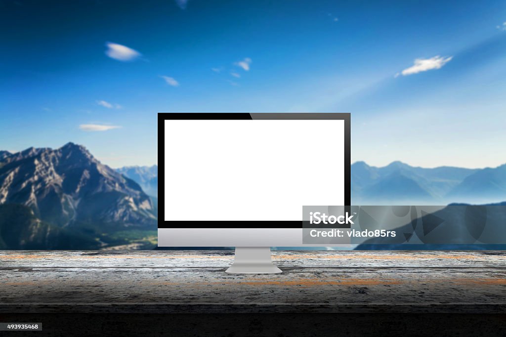 computer display on desk with mountain in the background computer display on desk with mountain in the background mock up presentation  2015 Stock Photo