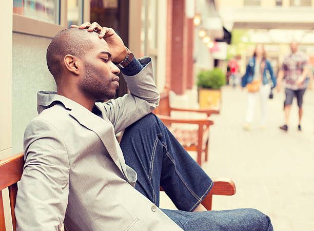 istock stressed sad young business man sitting outside office 493935560