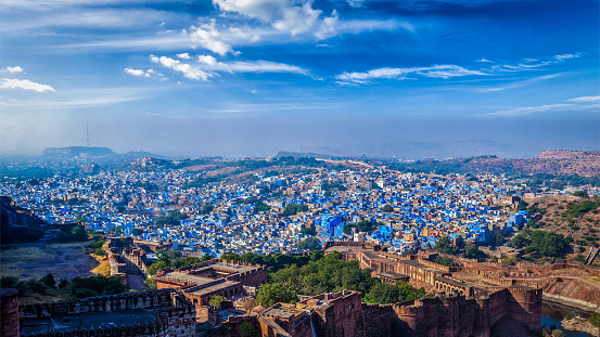 Aerial  panorama of Jodhpur, also known as Blue City due to the vivid blue-painted Brahmin houses. View from Mehrangarh Fort (part of fortifications is also visible).  Jodphur, Rajasthan, India