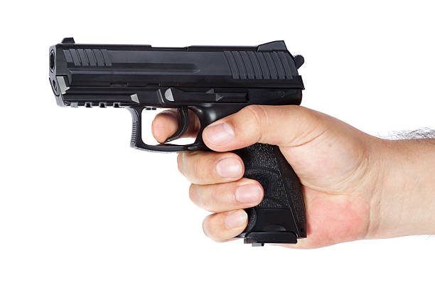 istock Gun in the hand isolated on white background 493936566
