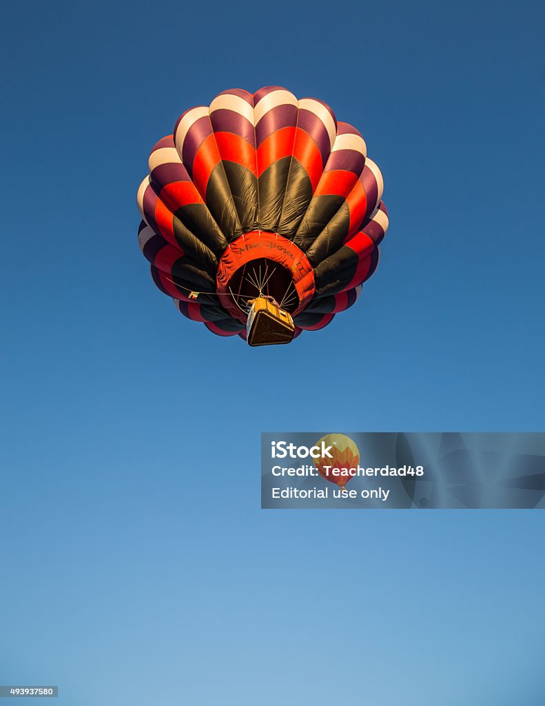 Hot Air Balloons Montague, California, USA-September 26, 2015: Two hot air balloons begin to float in pristine blue skies over a crowd of spectators in northern California during the Montague Hot Air Balloon Fair. 2015 Stock Photo