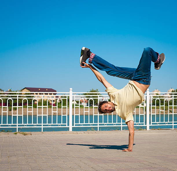 istock Man dancing yellow shirt blue jeans 493939546