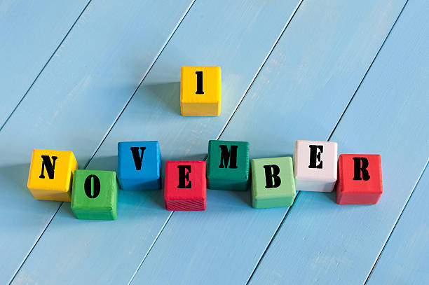 istock First November 1st sign on color wooden cubes with light 493940160