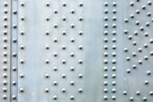 Steel plate background, closeup Harbour Bridge large steel beam with bolts, abstract background, full frame horizontal composition with copy space