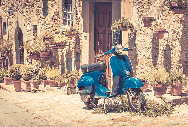 Scooter in Tuscany Scooter in front of old building in Cortona town, Tuscany moped stock pictures, royalty-free photos & images