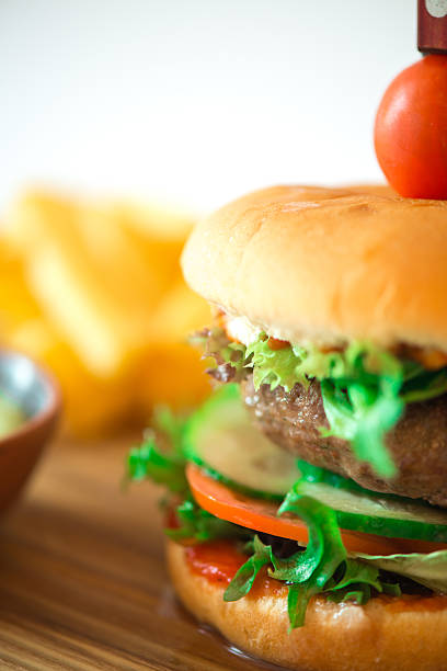 istock Beef burger on the wooden plate with fried potato 493944314