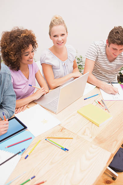 istock University students studying together at desk 493953731