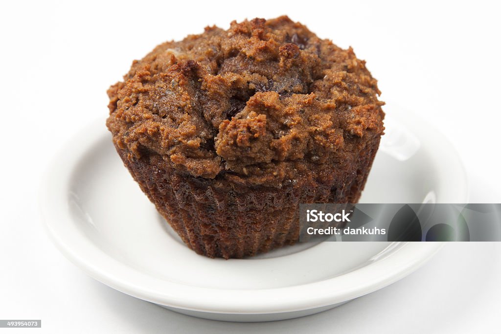 Muffin on a Plate A muffin sitting on a white saucer. Baked Stock Photo