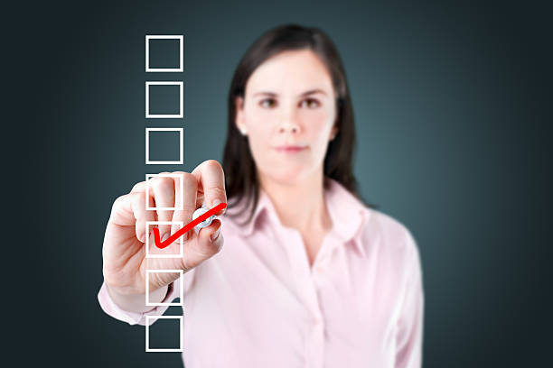 istock Young business woman checking on checklist box. 493954359