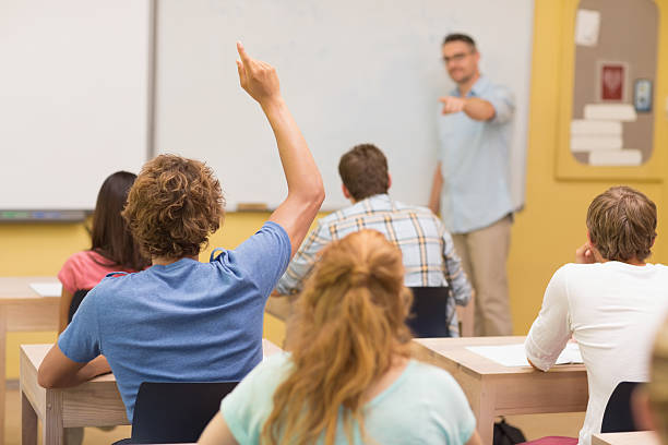 istock Male student answering in classroom 493956661