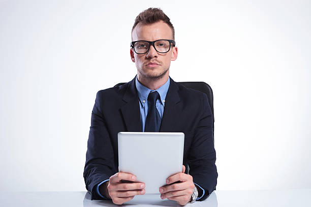 istock serious business man with tablet 493956931