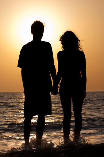 Couple in love looking at the sunset