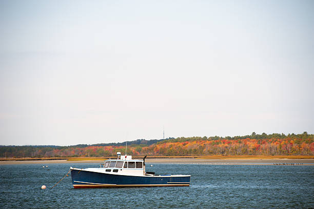 Lobster boat anchored in a Maine harbor in autumn stock photo