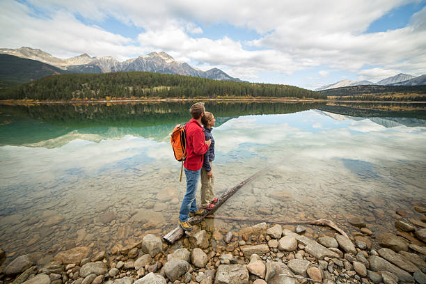 istock Couple standing on tree log contemplating nature 493972430