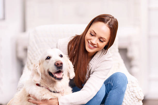 istock Young girl patting her pet dog 493972982